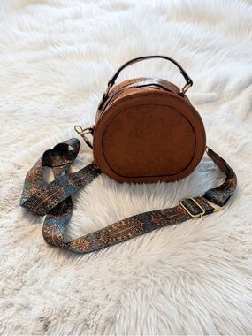Tan Round Crossbody Bag with Patterned Strap